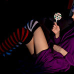 Pic of Teen solo girl with dyed hair and piercings bares her tits while licking candy