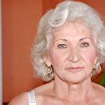 Pic of Lustful granny in white stockings masturbating her twat with a big dildo
