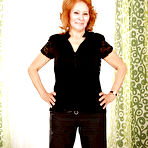 Pic of Filthy redhead granny with shaved cunt stripping and spreading her legs