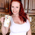 Pic of Busty mature mom Red Vixen takes out her huge puppies for kitchen spread