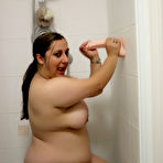 Pic of Fat amateur Kimberly Scott sucks and tit fucks a suction dildo in the shower
