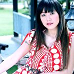 Pic of Hot Thai girl Jenny Lee picks up a sex toy while getting naked on a deck