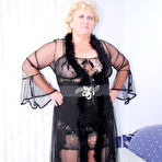 Pic of Fat nan Fanny frees her big butt and vagina from black lingerie in stockings