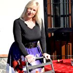 Pic of Blonde granny Melody displays her big ass while wearing a thong and fishnets