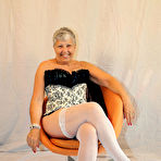 Pic of Granny first timer Savana holds her bare ass after pulling down a thong