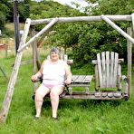 Pic of Old British woman Grandma Libby exposes her boobs on a backyard bench swing