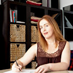 Pic of Mature redhead Gloria highlights her trimmed pussy during her first nude gig