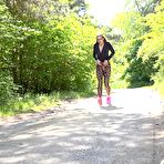 Pic of Pretty girl Barbara Bieber pees on a paved road in pink running shoes