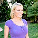 Pic of Natural blonde Krissy Lynn models clothed in yard wearing shorts