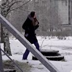 Pic of White girl pulls down her jeans to pee in the snow behind a building