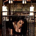Pic of Busty girl is freed from a cage for lesbian sex with a dominant woman